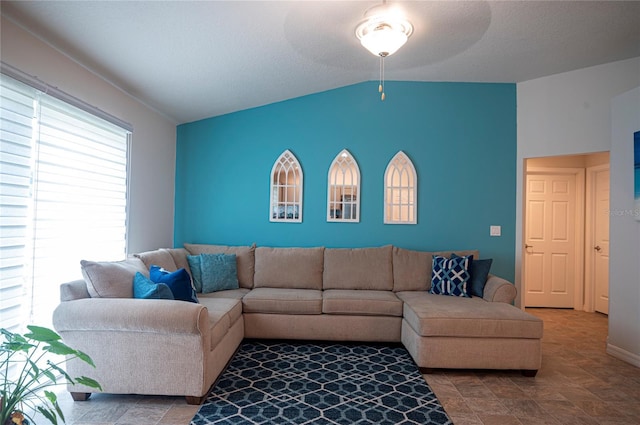 living room featuring vaulted ceiling and ceiling fan