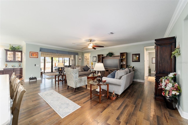 living room with crown molding, ceiling fan, and wood-type flooring