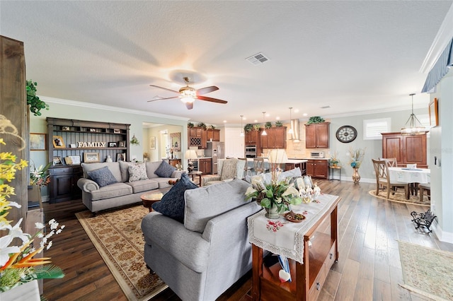 living room featuring a textured ceiling, crown molding, ceiling fan, and dark wood-type flooring