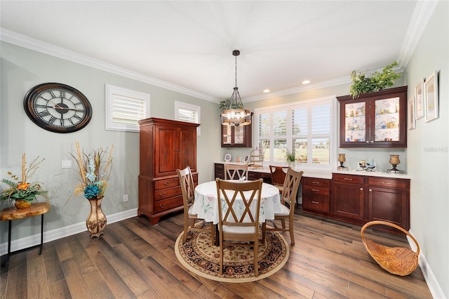 dining area featuring dark hardwood / wood-style floors, a wealth of natural light, and crown molding