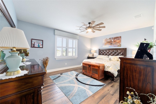 bedroom with ceiling fan and wood-type flooring