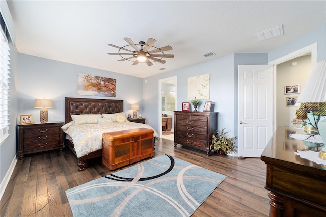 bedroom featuring ceiling fan, dark wood-type flooring, and connected bathroom