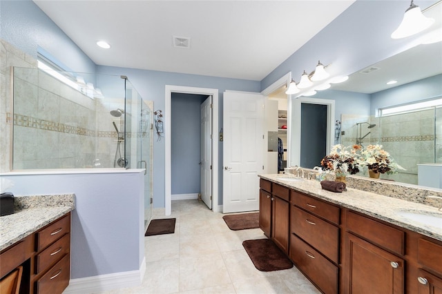 bathroom featuring tile patterned floors, vanity, and walk in shower