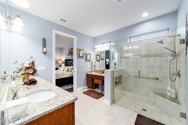 bathroom featuring tile patterned flooring, vanity, and walk in shower