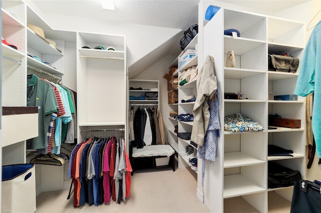 walk in closet featuring light colored carpet