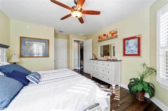 bedroom with ceiling fan and dark hardwood / wood-style flooring