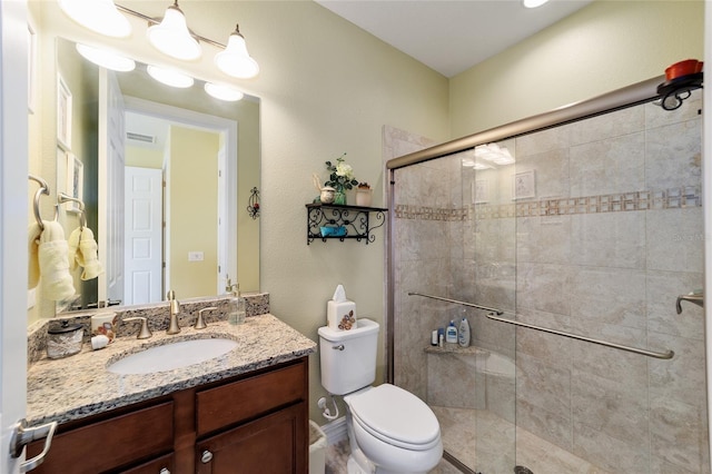 bathroom with vanity, toilet, and walk in shower