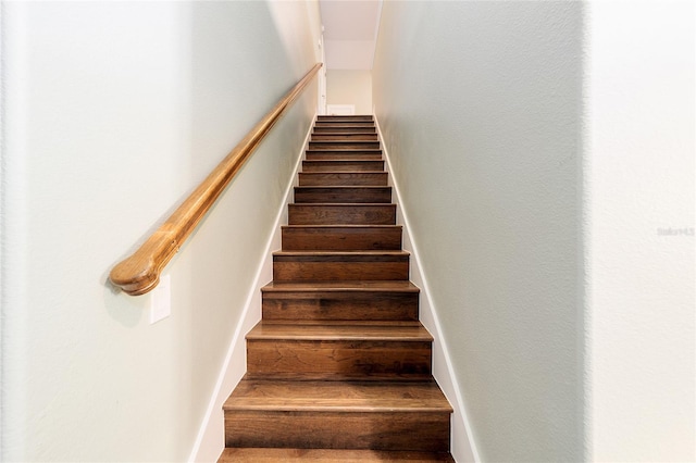 stairs featuring hardwood / wood-style floors