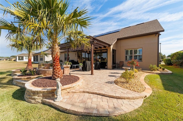 rear view of property featuring a lawn and a patio area