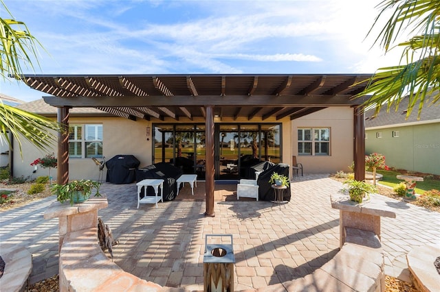 view of patio featuring a grill and a pergola