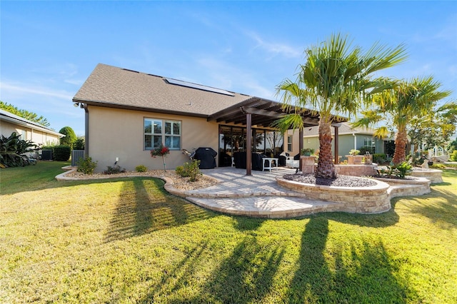 rear view of house featuring a patio and a lawn