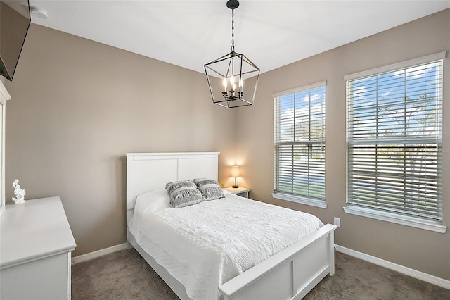 carpeted bedroom featuring a chandelier