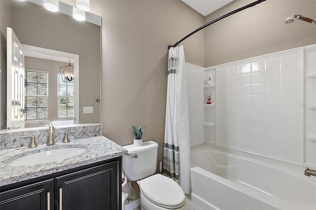 full bathroom with toilet, vanity, shower / bath combo, and a notable chandelier