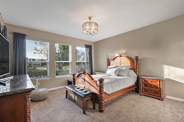 bedroom with a notable chandelier and carpet floors