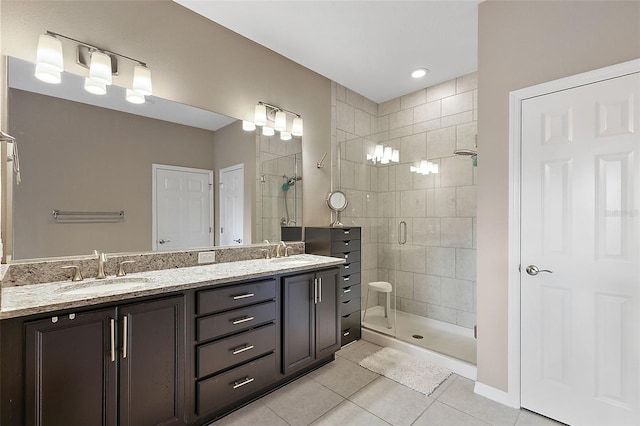 bathroom featuring tile patterned flooring, vanity, and a shower with door