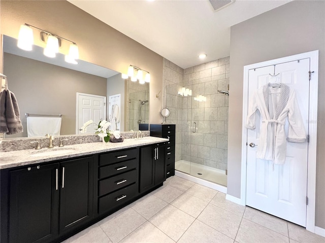 bathroom with tile patterned flooring, vanity, and a shower with door