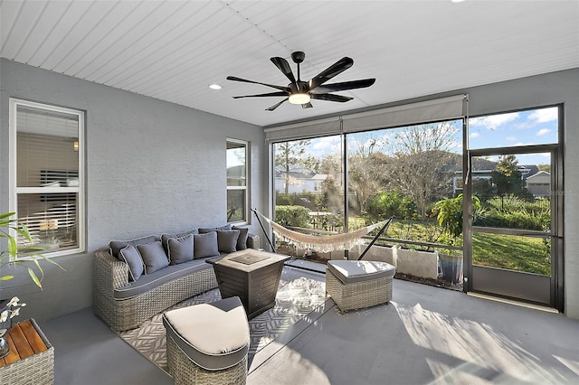 sunroom / solarium featuring ceiling fan and a healthy amount of sunlight