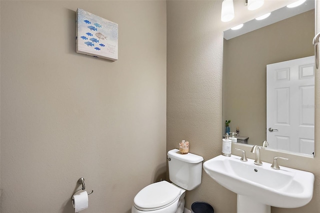 bathroom featuring sink and toilet