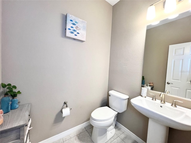 bathroom featuring sink, tile patterned flooring, and toilet