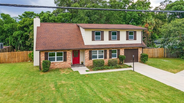 view of front of property with a front yard and a garage