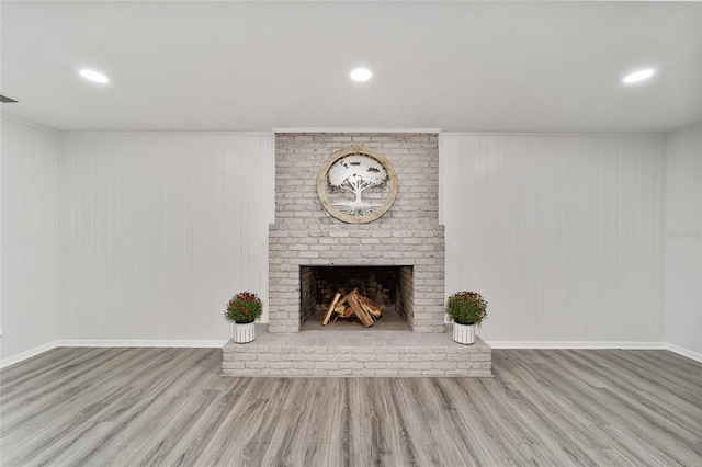 unfurnished living room with light hardwood / wood-style floors and a fireplace