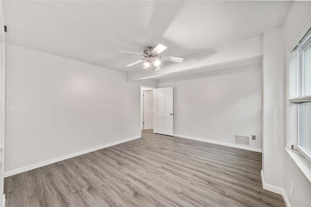 spare room featuring hardwood / wood-style flooring, ceiling fan, and a textured ceiling