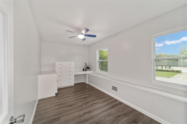 interior space featuring a textured ceiling, dark hardwood / wood-style flooring, and ceiling fan