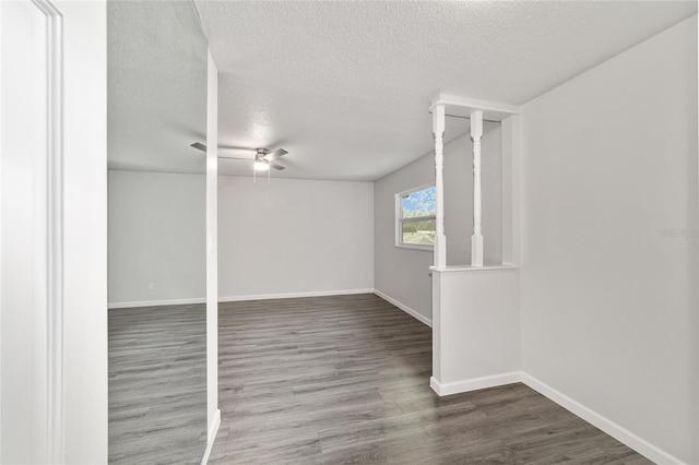 unfurnished room featuring ceiling fan, wood-type flooring, and a textured ceiling