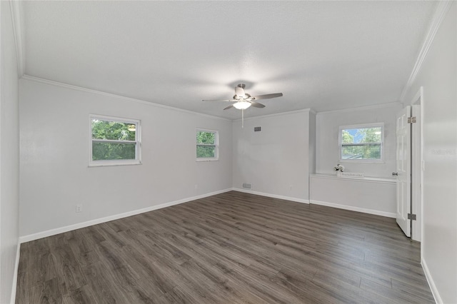 unfurnished room featuring dark wood-type flooring, crown molding, ceiling fan, and a healthy amount of sunlight