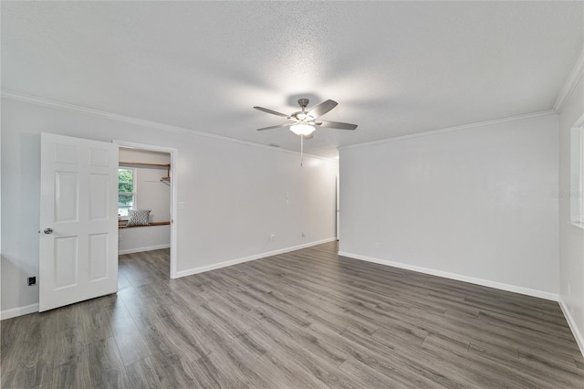 unfurnished room featuring a textured ceiling, dark hardwood / wood-style floors, ceiling fan, and crown molding