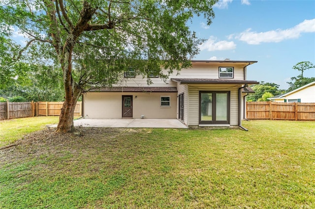 back of property featuring a patio and a lawn