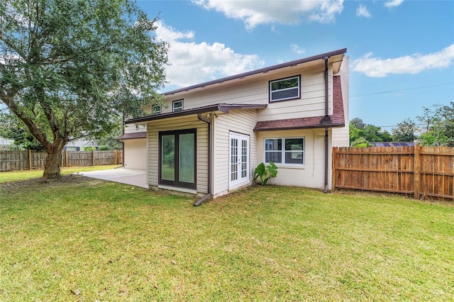 back of house with a yard and a patio