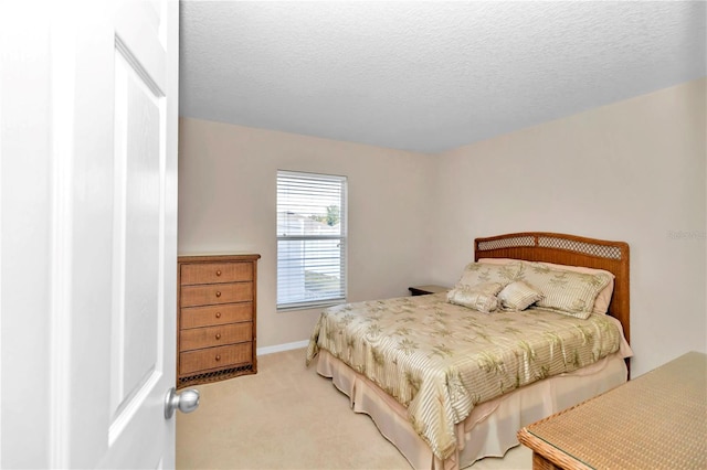 carpeted bedroom with a textured ceiling