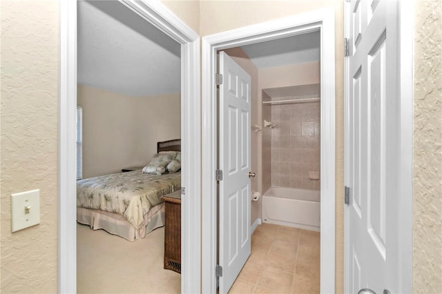 interior space featuring tiled shower / bath combo and tile patterned floors