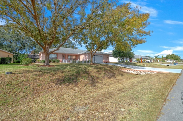 ranch-style home with a front yard and a garage