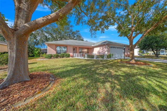 ranch-style home featuring a front lawn and a garage