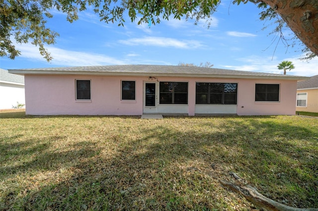 rear view of house with a yard