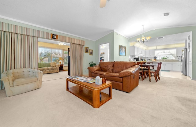 living room featuring crown molding, plenty of natural light, light colored carpet, and vaulted ceiling