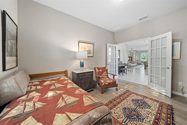 bedroom with light hardwood / wood-style flooring and lofted ceiling