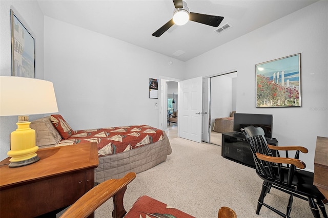 carpeted bedroom featuring a closet and ceiling fan