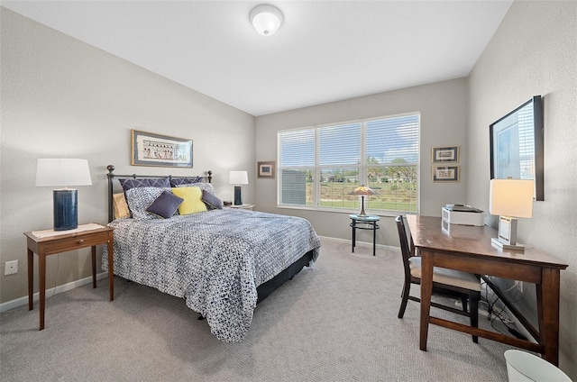 carpeted bedroom with lofted ceiling