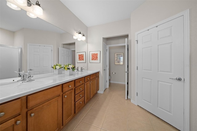 bathroom featuring tile patterned floors, vanity, and toilet