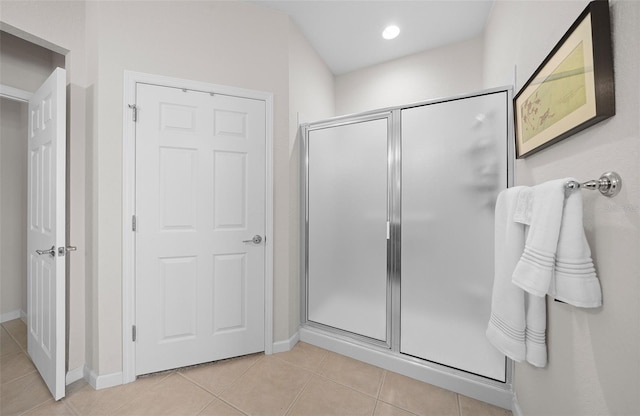 bathroom with tile patterned floors and a shower with shower door