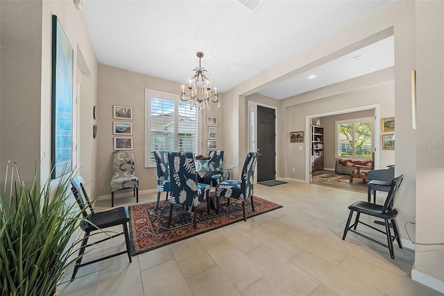 dining area featuring light tile patterned floors and a chandelier