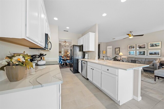 kitchen featuring kitchen peninsula, ceiling fan with notable chandelier, stainless steel appliances, and white cabinetry