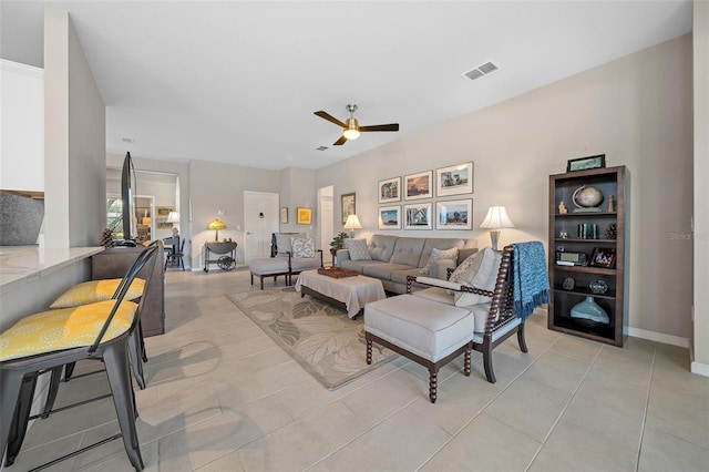 tiled living room featuring ceiling fan