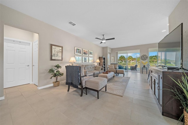 tiled living room with ceiling fan