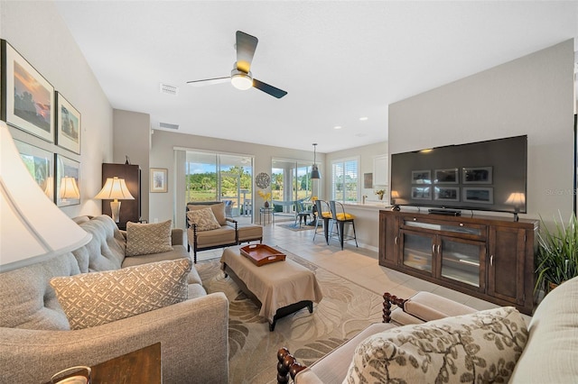 tiled living room with ceiling fan