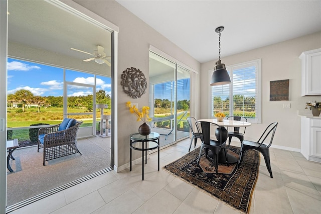 dining area with light tile patterned floors and ceiling fan