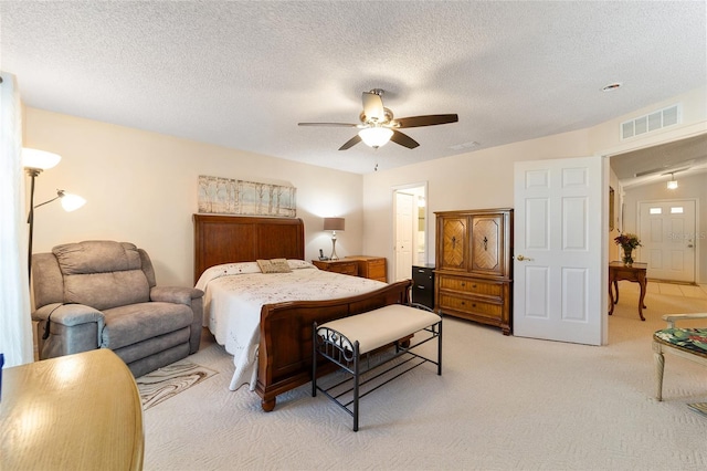 carpeted bedroom with vaulted ceiling, ceiling fan, and a textured ceiling